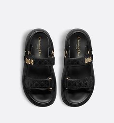 The Dioract sandal presents a modern silhouette in black calfskin quilted with the Cannage motif. The style features an anatomically shaped sole made with ultra-lightweight and comfortable leather. Self-fastening straps further enhanced by a gold-finish metal Dior signature on the upper strap complete the design. The sandal will lend a contemporary touch to any look.. 40.5 Dioract Sandal, Dior Sandals, Denim Swimsuit, Dior Star, Icon Shoes, Ballerina Pumps, Dior Book Tote, Star Shoes, Backpack Tote Bag