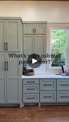 a kitchen with gray cabinets and white counter tops is featured in the video, what's your cabinet paint color?