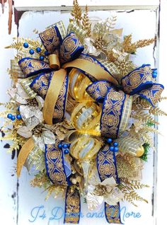 a blue and gold wreath on a white door