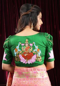 This exquisite blouse boasts a hand-painted design of the goddess Lakshmi on  green pure raw silk fabric. The blouse features puff sleeves and intricate crystal detailing that adds a touch of glamour to its overall appearance. Need minor customizations such as altering the sleeve length or neckline? Or if you are looking for a custom size. Ask us and we will try our best to make it happen! Other Details: Size : Made as per the standard measurements for the size chosen. Padding: Yes Lining: Yes M Lakshmi Photos, Latest Blouse Designs Pattern, Net Blouses, Raw Silk Fabric, Unique Blouse, Goddess Lakshmi, Fancy Blouses, Fancy Blouse Designs, Embroidery Blouse Designs