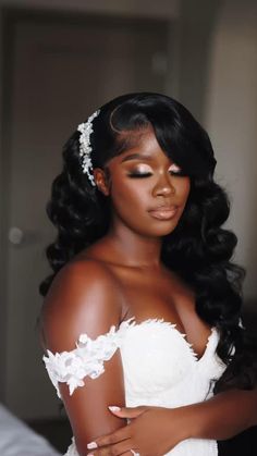 a woman in a wedding dress with her arms around her chest and wearing a tiara