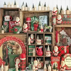 an assortment of christmas items on display in a room with wooden crates and other decorations