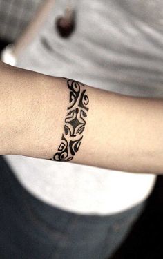 a woman's arm with a tattoo on it that has an intricate design in the middle