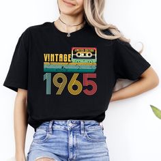 a woman wearing a black shirt with the words vintage on it