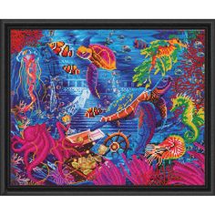 a cross stitch kit with an underwater scene in blue and orange colors, including corals,