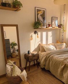 a bed sitting in a bedroom next to a window with plants on top of it