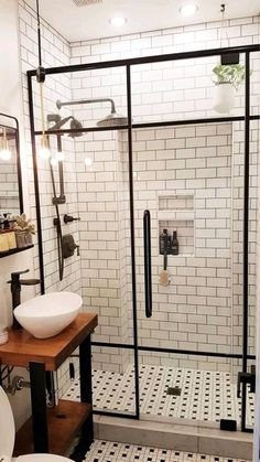 a bathroom with a sink, toilet and shower stall