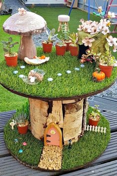 a table with plants and mushrooms on it in the middle of a yard, surrounded by potted plants