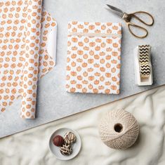 wrapping paper and craft supplies laid out on a table