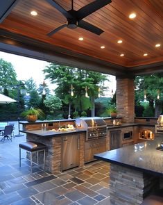 a large outdoor kitchen with an island and grill