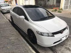 a white car parked on the side of a street