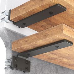 two brackets are attached to the underside of a wooden table top with metal brackets on it