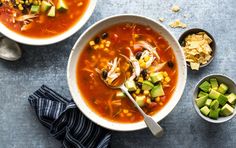 two bowls of vegetable soup on a table