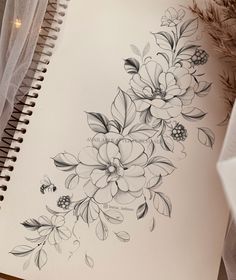 an open notebook with flowers drawn on it