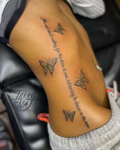 a woman's back with butterflies on it and the words written in cursive writing