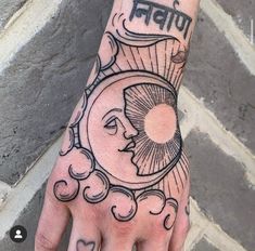 a person's hand with a sun and clouds tattoo on it