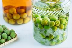 two jars filled with green and yellow fruit