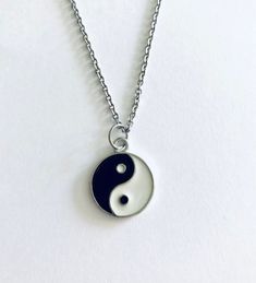 "Yin and Yang necklace, black and silver duality ying & yang necklace, on a silver dainty STAINLESS STEEL chain *STAINLESS STEEL chain *chain measures approx 18\" inches long *charm measures approx 1\" inches long *has lobster claw claps closure *charm is double sided *charm is alloy Yin & Yang is a concept of dualism with its roots in Taoism/ philosophy. The Yin or dark side is associated with shadows, femininity & the trough of a wave, the Yang or light side represents brightness, passion & gr Trendy Black Sterling Silver Necklace, Hypoallergenic Black Stainless Steel Necklace, Black Sterling Silver Nickel Free Charm Necklace, Black Sterling Silver Nickel-free Charm Necklace, Nickel-free Black Round Pendant Charm Necklace, Black Nickel-free Sterling Silver Charm Necklace, Yen And Yang, Taoism Philosophy, Yin And Yang Necklace