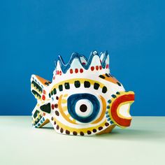 a ceramic fish with a crown on it's head