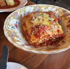 lasagna casserole with meat sauce and cheese on a floral pattern plate