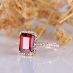 ※ Metal Type: Solid 10k/14k (White/Yellow/Rose) Gold. ※ Center Stone: Natural Red Garnet ※ Center Carat Weight: Emerald Cut 2.00CT (6x8mm). ※ Center Stone Clarity & Color: VS & Red - 3A ※ Accents Side Stones: Esdomera Moissanites -0.23ctw (DEF, VVS1)\ ※ Accessories: *Shipped with beautiful ring box; *Directly price from Manufacturer, 1/3 the price from Jewelry Store; ※ Buy with Warranty: 1) 15 Days Money Back Guarantee; 2) Excellent Customer Service; 3) Free Shipping and insurance to WOR Rose Gold Ruby Ring With Halo Setting For Anniversary, Rose Gold Ruby Ring With Halo For Anniversary, Rose Gold Emerald Cut Ruby Ring For Wedding, Garnet Engagement Ring, Halo Engagement Rings, Garnet Rings, Ruby Ring, Halo Rings, Emerald Cut