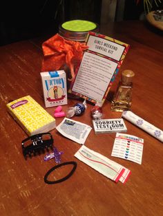 an assortment of items on a table with a gift bag and other items around it