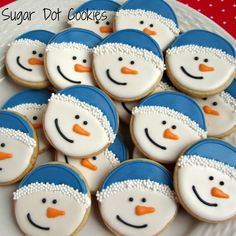 frosted snowman cookies are arranged on a plate