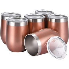 a set of six stainless steel cups with lids