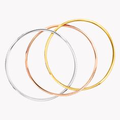 An eye-catching trio of interwoven bracelets perform endless rotations as they swirl elegantly around the wrist in our triple Spiral bangle, revealing their playful personalities. Contrasting white, yellow and rose gold, each sculpted curve is enhanced with pavé diamonds that catch and reflect the light as the bangles twist and turn with each gesture of the hand. The Spiral collection features delicate gold and pavé diamond jewels that are designed to be stacked and mixed and matched, alongside Triple Spiral, Spiral Jewelry, Graff Diamonds, Pave Diamond Band, Rose Gold Bangle, Diamond Jewel, Pave Diamond Ring, Pendant Watches, White Gold Diamond Rings