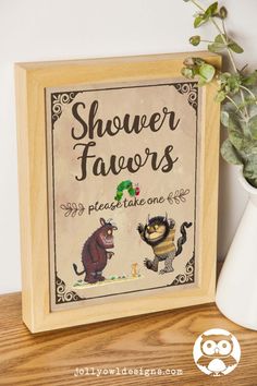 a sign that says shower favors and there is a potted plant next to it