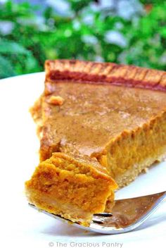 a slice of pumpkin pie on a plate with a fork