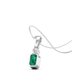 Enhance your elegance with our stunning emerald pendant featuring a dazzling diamond set in luxurious white gold. This exquisite piece exudes sophistication and charm, making it the perfect accessory for any special occasion or everyday wear. Metal: 14K Gold Setting Type: Prong Rhodium Finish: Yes, on White Gold Gemstone Details: Gemstone: Emerald Shape: Emerald Cut Average Dimensions: 5.00 x 3.00 MM Quantity: 01 Average Cut: Very Good Average Color: Medium to Dark Green Average Clarity: Eye Cle Formal Emerald Diamond Necklace In White Gold, Formal White Gold Emerald Diamond Necklace, Elegant White Gold Emerald Necklace With Diamonds, Elegant White Gold Emerald Necklace With Brilliant Cut, Elegant White Gold Emerald Necklace For Anniversary, Classic White Gold Emerald Necklace With Diamond Accents, Classic Silver Diamond Emerald Necklace, Classic Silver Diamond Necklace With Emerald, Elegant Emerald Cut Diamond Emerald Necklace