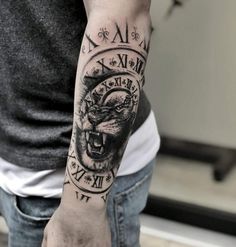 a man with a tattoo on his arm and wrist is holding a clock in the shape of a gorilla