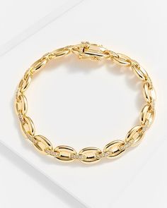 For a smooth and cultured style, choose the Gina Gold Chain Link Bracelet. Made with 14k gold-plated authentic sterling silver, the finish is one that shines with intensity. Chunky, oval-shaped links are connected with clear diamonette bedazzled bands to complete the look. With a double safety clasp to ensure it stays in place, this gorgeous piece exudes opulence for any occasion. By day, it adds a signature touch to your wardrobe while by night, it can bring out the elegance of any understated Gold Oval Bracelet With Cubic Zirconia, Luxury Oval Link Chain Bracelet For Anniversary, Gold Jewelry With Diamond Accents And Oval Link, Modern Yellow Gold Oval Diamond Bracelet, Classic Gold Diamond Chain Bracelet, Elegant Diamond Chain Bracelet With Oval Links, Classic Gold Chain Bracelet With Diamond Accents, Classic Formal Diamond Bracelet With Chain Link, Classic Diamond Oval Link Chain Bracelet