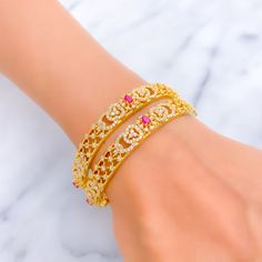 This pair of 22k gold bangles, with a total weight of 44.5 grams, features a radiant and impressive design, adorned with cubic zirconia stones that highlight the intricate floral patterns set in a gleaming yellow gold finish. The bangles are sized at 2.5, with an opening diameter of 2.3 inches, ensuring a comfortable fit for the wearer. Comprising two pieces, this set exemplifies luxury and elegance, perfect for those who appreciate the blend of traditional floral motifs with the sparkling allure of cubic zirconia. Ideal for adding a touch of sophistication to any ensemble, these bangles are a testament to exquisite craftsmanship and timeless style. PRODUCT DETAILS Gold Purity(karat): 22k Gold Weight(grams): 44.5 Item Finish: Yellow Gold Stone: Cubic Zirconia Bangle Size: 2.5 Bangle Openin Gold Bangle With Intricate Design In Cubic Zirconia, Gold Bangle With Intricate Cubic Zirconia Design, Festive Gold Cubic Zirconia Bracelets, Festive Gold Cubic Zirconia Bracelet, 22k Gold Bangles, The Bangles, Gold Stone, Floral Motifs, 22k Gold