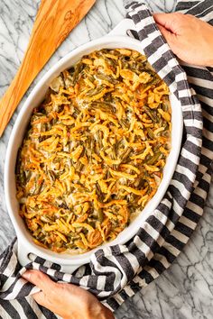 a white dish filled with green bean casserole