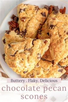 chocolate pecan scones on a plate with the words buttery flaky delicious