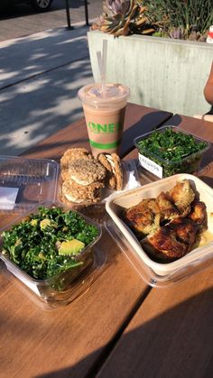 some food is sitting on a wooden table with a cup of coffee next to it