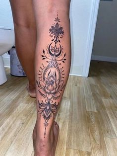 a woman's leg with tattoos on it, and a flower in the center