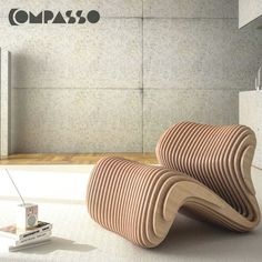 an unusual wooden chair sitting on top of a white floor next to a wall with the word ompas