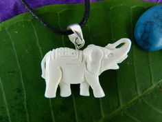 "This hand carved white elephant necklace is part of our spirit animal collection. The elephant is a symbol of compassion and power. The gentle giants are known for forming emotional bonds and protecting their loved ones with their strength. The elephant totem represents benevolence, grace, and fortitude. Each necklace is individually hand carved and has the following dimensions. Length = 0.75\" Width = 1.5\" Material Options: Bone, Sawo Wood Please note that each Spirit Necklace is hand carved White Carved Spiritual Jewelry, White Carved Pendant Necklaces, White Carved Pendant Necklace, White Carved Amulet Necklace, White Bohemian Engraved Necklace, Wood Puzzle Box, Carved Necklace, Necklaces White, Pewter Plates