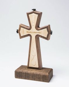 a wooden cross with the word jesus's name engraved on it