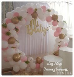 the balloon arch is decorated with pink, white and gold balloons