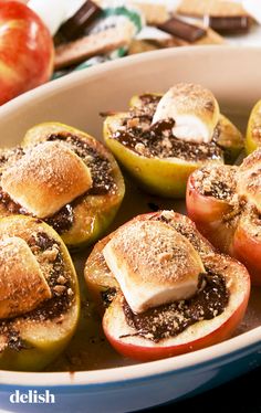 baked stuffed apples in a baking dish with toppings