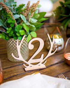 the table is set with two deer head centerpieces