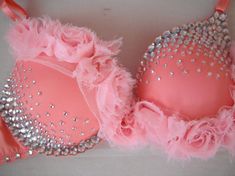 two bras with pink and silver sequins on them