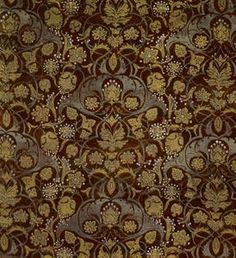 an intricately designed area rug in brown and gold