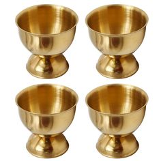 four brass bowls sitting on top of each other