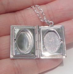 "This Awesome 1\" x 3/4\", Silver tone, Book Locket, made from a Vintage Stamping,) necklace has a Hand Carved, Vintage Shell Cameo nestled in the center, accented by red Swarovski Crystals. Inside the Locket will hold two, 10mm x 15mm, oval photos of your favorite people, or pets. The necklace comes on an 23\", silver tone, tarnish resistant, chain, with a lobster claw clasp. If a shorter chain is desired, just let me know, in the space provided at checkout. This is a really unique and beautifu Retro Nickel Free Jewelry For Gifts, Vintage Silver Jewelry For Gift Making, Retro Sterling Silver Jewelry Gift, Retro Sterling Silver Jewelry For Gift, Retro Nickel Free Necklace For Gift, Retro Engraved Necklaces For Gifts, Retro Rectangular Jewelry Gift, Vintage Necklace With Rectangular Pendant For Anniversary, Vintage Necklaces With Rectangular Pendant For Anniversary