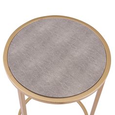 a round metal table with a mesh top and gold frame, on a white background